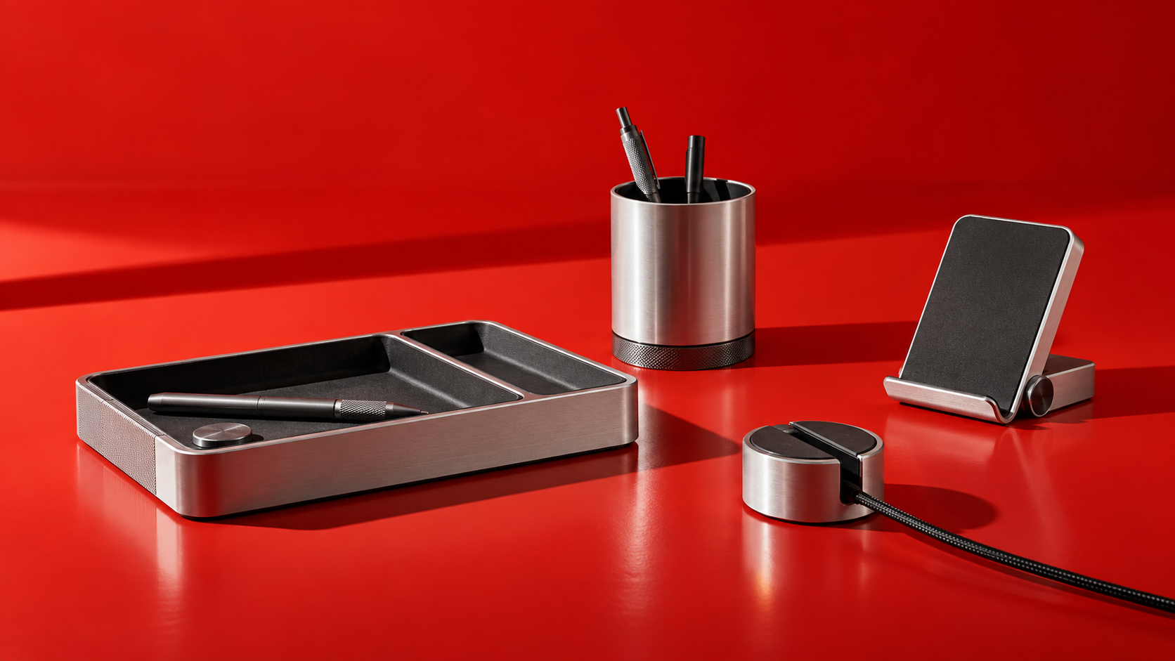 Rivetday machined aluminium desktop collection on a vermilion surface